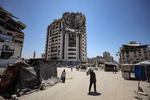 Makeshift tents erected by displaced Palestinians among buildings damaged by Israeli attacks