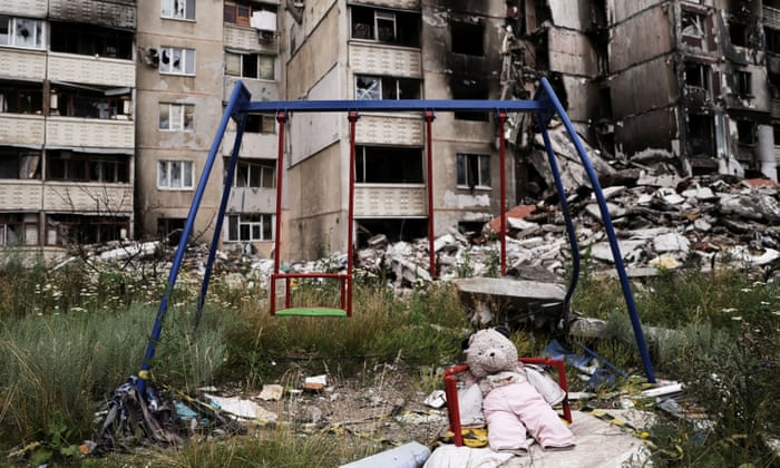A teddy bear is seen next to a swing, next to buildings destroyed by Russian missile strikes in Saltivka, one of the most damaged residential areas of Kharkiv, Ukraine, on 17 July.