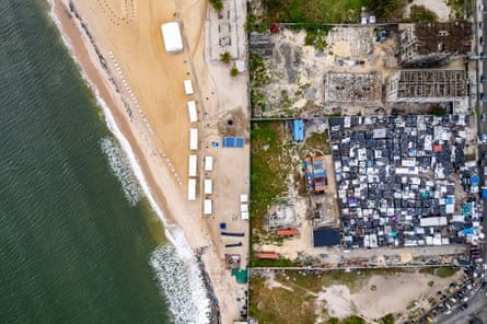 Aerial view of a quiet-looking beach walled off from the inland