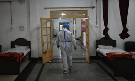 A health worker inspects beds at a temporary Covid-19 hospital in Srinagar