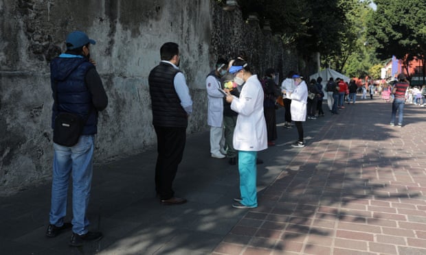 People wait in line before healthcare worker take samples for the coronavirus test at Coayoacan park, in Mexico City, Mexico, on 22 October.