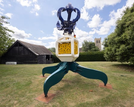 A large metal sculpture sits on a lawn