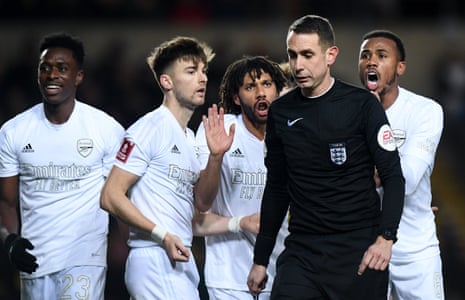 Referee David Coote ignores the Gunners protests.