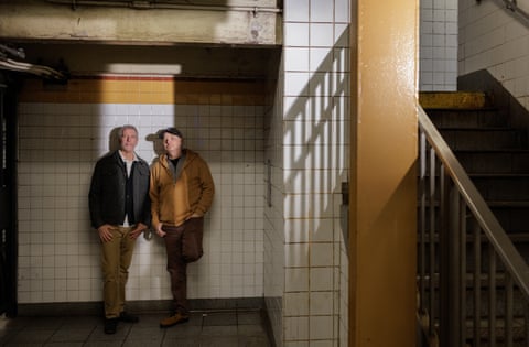 Danny and Pete standing against a white tiled wall in a subway in New York