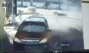 A still from a video reportedly showing two motorbikes exploding outside police headquarters in Surabaya, Indonesia.