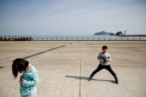 Chan-hee, 10, and his younger sister Chae-hee, seven, rollerblade together on the seafront