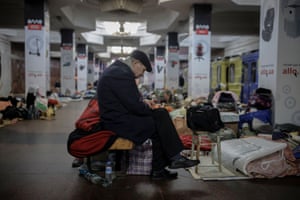 A man sits in a metro station in northern Kharkiv where he lives to shelter from shelling in his neighbourhood.