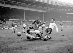 Greaves (right) slides the ball past the Rest of the World goalkeeper Milutin Soskic to score the decisive goal during the FA centenary match at Wembley in October 1963. England won 2-1