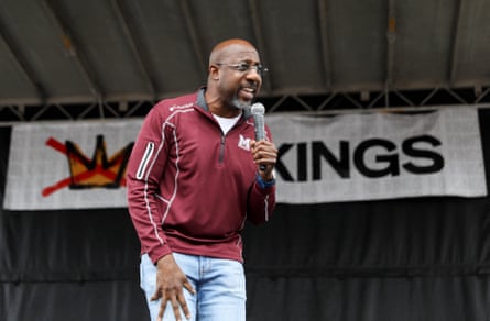 a man speaks into a microphone on stage