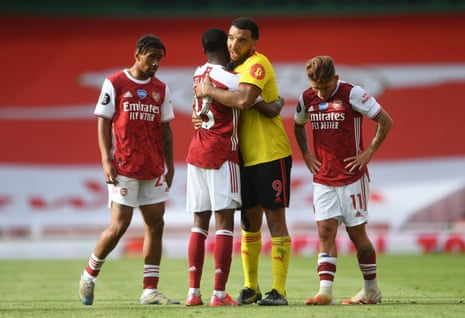 Deeney embraces Maitland-Niles after Watford are relegated from the Premier League.