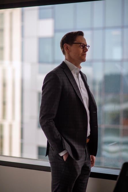 A man in a suit poses for a portrait