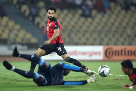 Sudan’s goalkeeper Mohamed Mustafa stops the ball from reaching Egypt’s Mohamed Salah as he lurks at the far post.