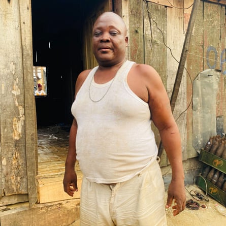 ‘They told us to leave. They didn’t tell us where to go’: the demolitions destroying homes and lives in Lagos A man in a white vest and shorts standing outside a wooden house