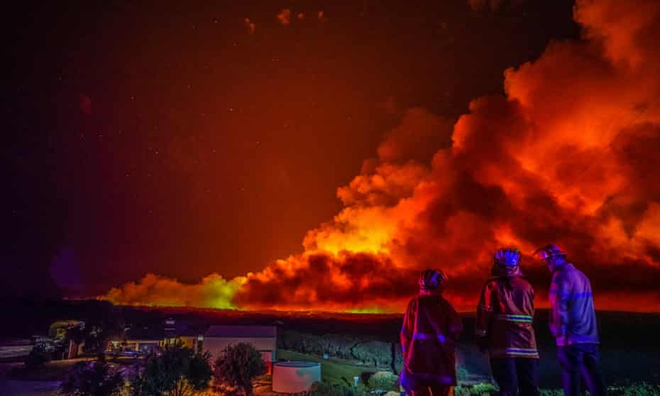 A firefighting crew watch the bushfire raging in Leeuwin-Naturaliste national park, Western Australia