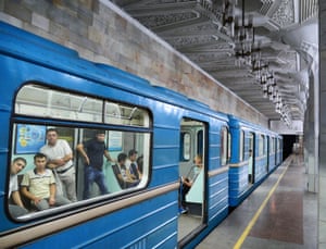 Commuters peer out at the novel sight of a foreigner taking photos of their metro
