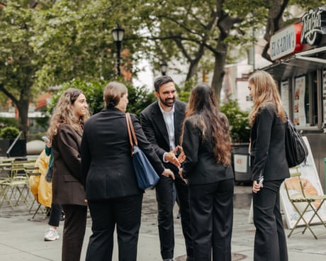 a man shaking hands with young women