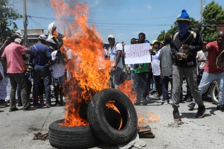 A demonstrator holds a banner which reads ‘Down with the impunity’ during a protest against insecurity and demands for the resignation of Prime Minister Ariel Henry in Port-au-Prince, Haiti, on 17 September 2023.