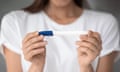 A woman holds a pregnancy test