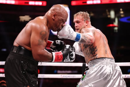 Jake Paul (right) punches Mike Tyson during their fight last November.