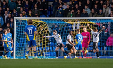 Crawley Town forward Ashley Nadesan (centre left) puts Crawley Town ahead against AFC Wimbledon.