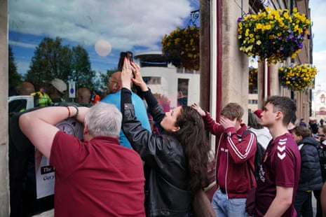 Hearts fans watch the title decider against Celtic through the windows of Edinburgh’s Tynecastle Arms.