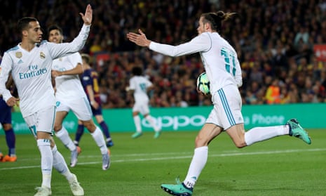 Gareth Bale (right) runs back to the centre circle with the ball after scoring.