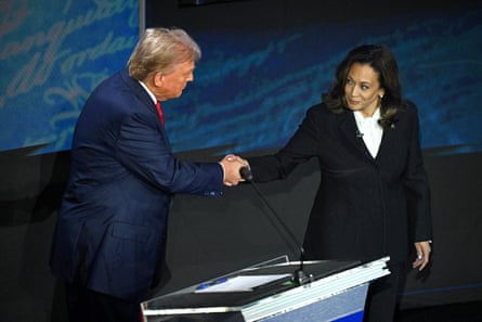 man (Trump) shakes hands with woman (Harris)