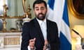 Humza Yousaf speaks at a press conference in front of a Scottish saltire flag