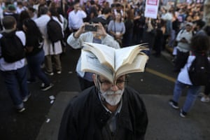 A man wears an open book on top of his head as he joins anti-government protests in Buenos Aires, Argentina