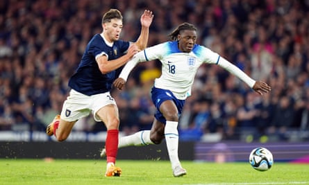 Eberechi Eze dribbles past a Scotland defender.