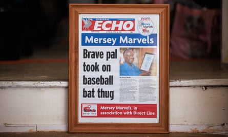 A framed newspaper front page reading: ‘Mersey Marvels: Brave pal took on baseball bat thug.’