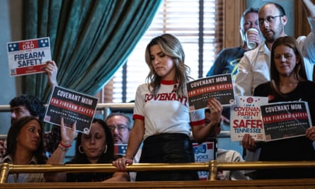 Mary Joyce, a Covenant school mother, holds a sign in the senate gallery above the chamber floor advocating for reform during a special session to discuss gun violence in the wake of the Covenant school shooting in Nashville