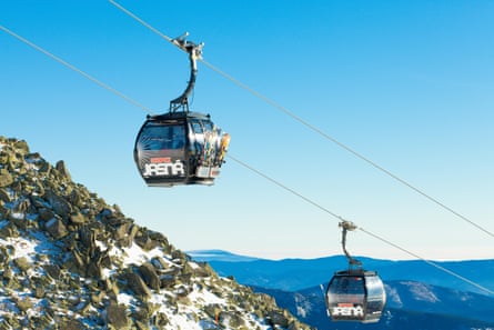 Two cable car cabins moving up to the very top of Chopok mountain at Jasna ski resort - Slovakia