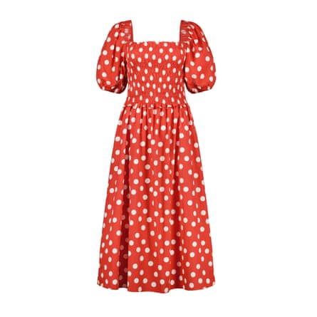 A red with white spots smock midi dress on a white background.