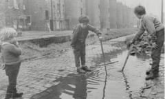 Children playing in puddles in the Gorbals district of Glasgow in 1969.