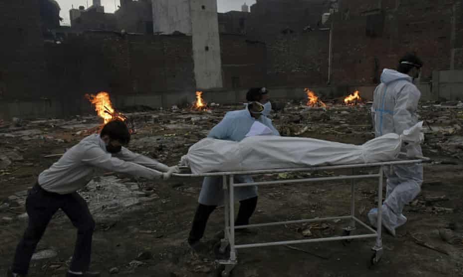 The body of a Covid-19 victim is wheeled in for cremation on Thursday on ground converted into a crematorium in Delhi