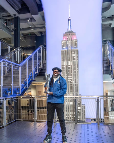 Chris Gayle holds the ICC trophy on a viewing platform with the Empire State building in the background