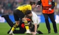 Borussia Dortmund's Marcel Sabitzer tackles a pitch invader shortly after the start of the Champions League final.