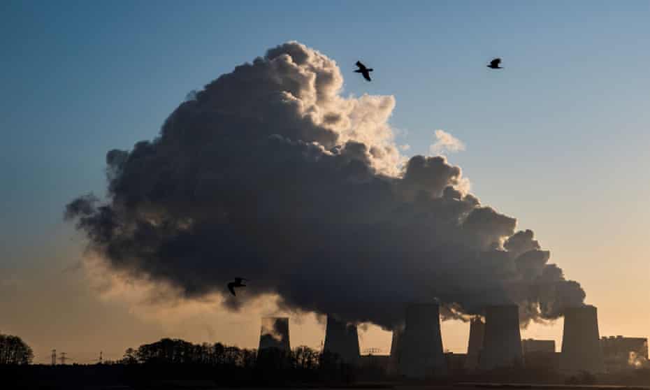 smoke and vapour rising from cooling towers and chimneys of coal-fired power plant