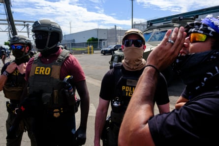 a man chants near men in tactical gear