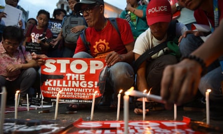 Activists light candles in front of a church in Manila during a vigil for victims of extra-judicial killings in the government’s drug war.
