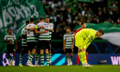 Steffen Tigges of Borussia Dortmund drops to his haunches at the final whistle as Sporting’s players celebrate reaching the Champions League knockout phase. 