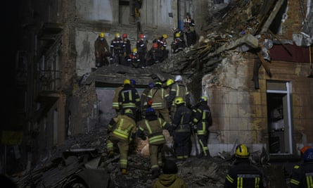 Rescuers work at the site of a residential building damaged by a Russian missile in Kryvyi Rih in December.