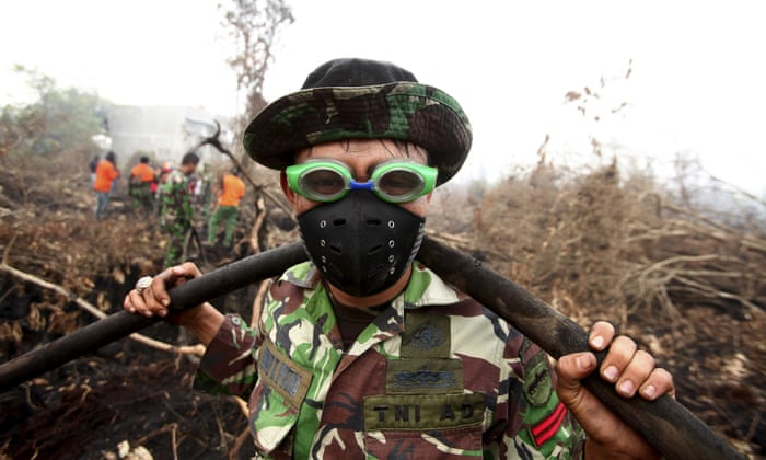 Parit Indah, Indonesia<br>A soldier uses swimming goggles to protect his eyes from smoke while helping to fight a fire in a peatland forest area. Seasonal forest fires have covered large parts of the island of Sumatra and Kalimantan in smoke and haze