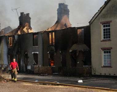 Emergency services fight fires in a row of houses in Wennington, England.