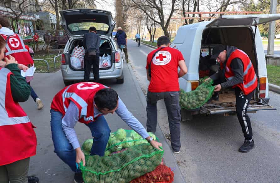 Russia-Ukraine war latest: Ukraine offers unconditional talks on Mariupol as west warns of Russian cyber-attacks – live | Ukraine 1 Ukrainians work in a Red Cross volunteer’s centre in Kharkiv, Ukraine.