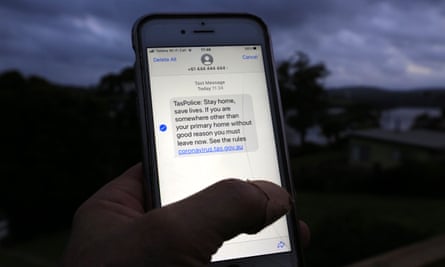 A man reads a mass emergency text message sent to Tasmanian citizens from police, near Launceston, Tasmania, Australia.