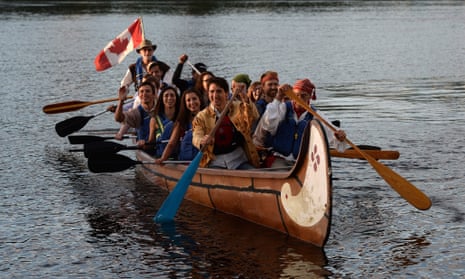 Canada's prime minister, Justin Trudeau, paddles in a a voyageur canoe on the Ottawa River following the National Aboriginal Day Sunrise Ceremony in Gatineau, Quebec, on Tuesday, June 21, 2016. The federal government began observing National Aborginal Day on June 21 two decades ago. (Sean Kilpatrick/The Canadian Press via AP) MANDATORY CREDIT