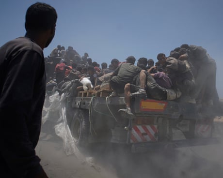 Palestinians hold on to an aid truck returning to Gaza City