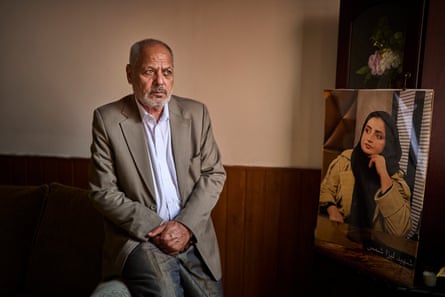 Shamsuddin Shams, with a portrait of his daughter Liza who was murdered by her husband in Afghanistan.
